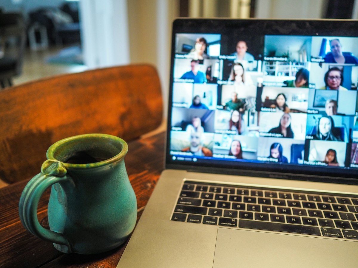 Remote engineering team participating in a multi-track video conference on a laptop